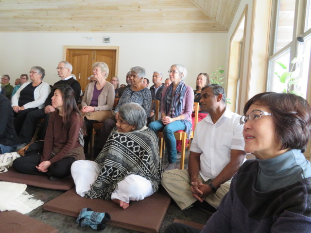 Community members observe Pabbajja in the Dhamma Hall.JPG
